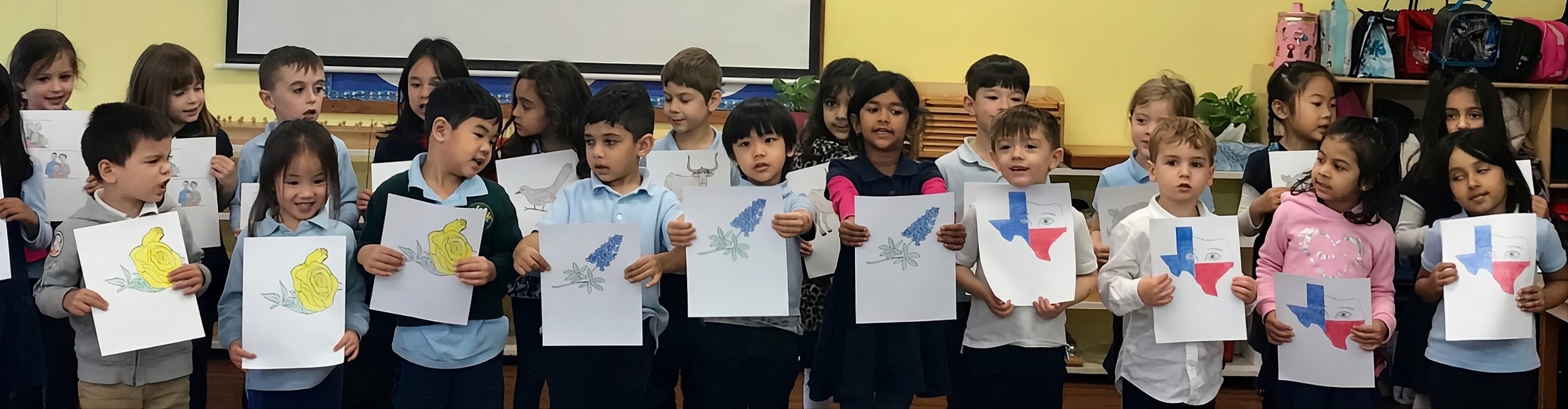 group of children holding paper and showing their work
